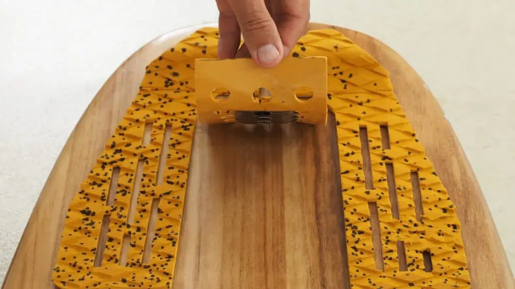 Putting on skimbaord traction pads on a skimboard