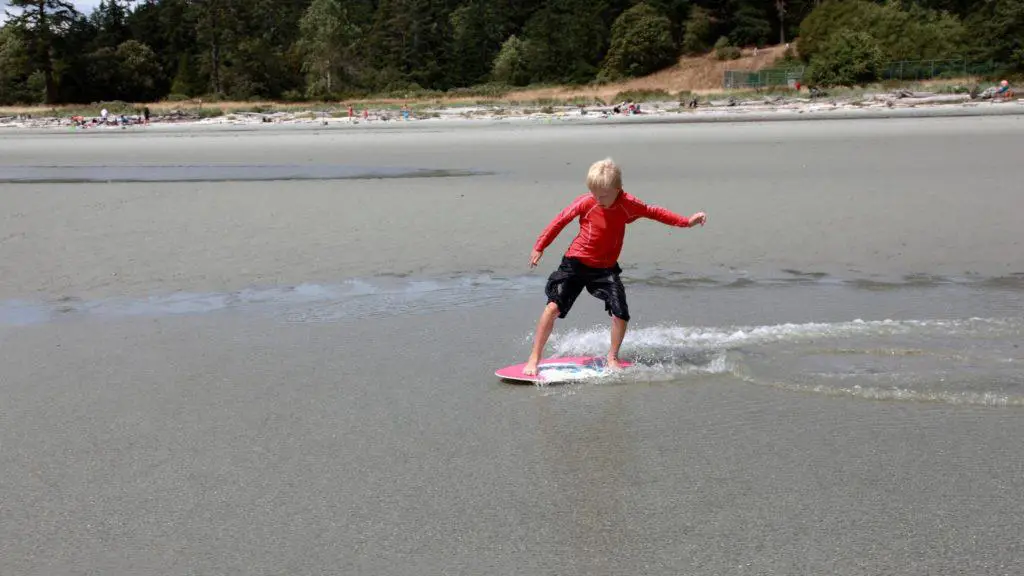 Child inland skimboarding on a lake