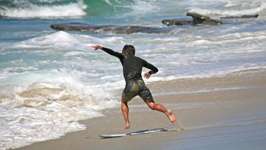 Skimboarder jumping on a skimboard