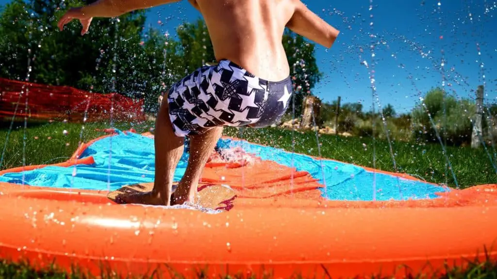 Skimboarding on a slip and slide